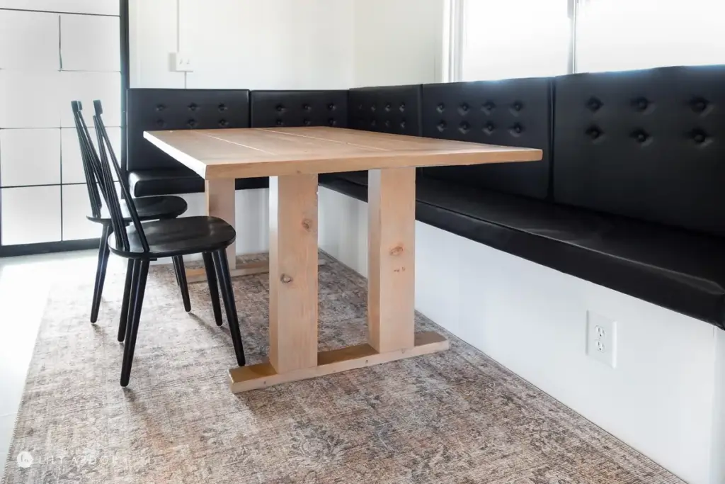 Modern DIY farmhouse dining table made from stained Douglas Fir with a pocket screw base.