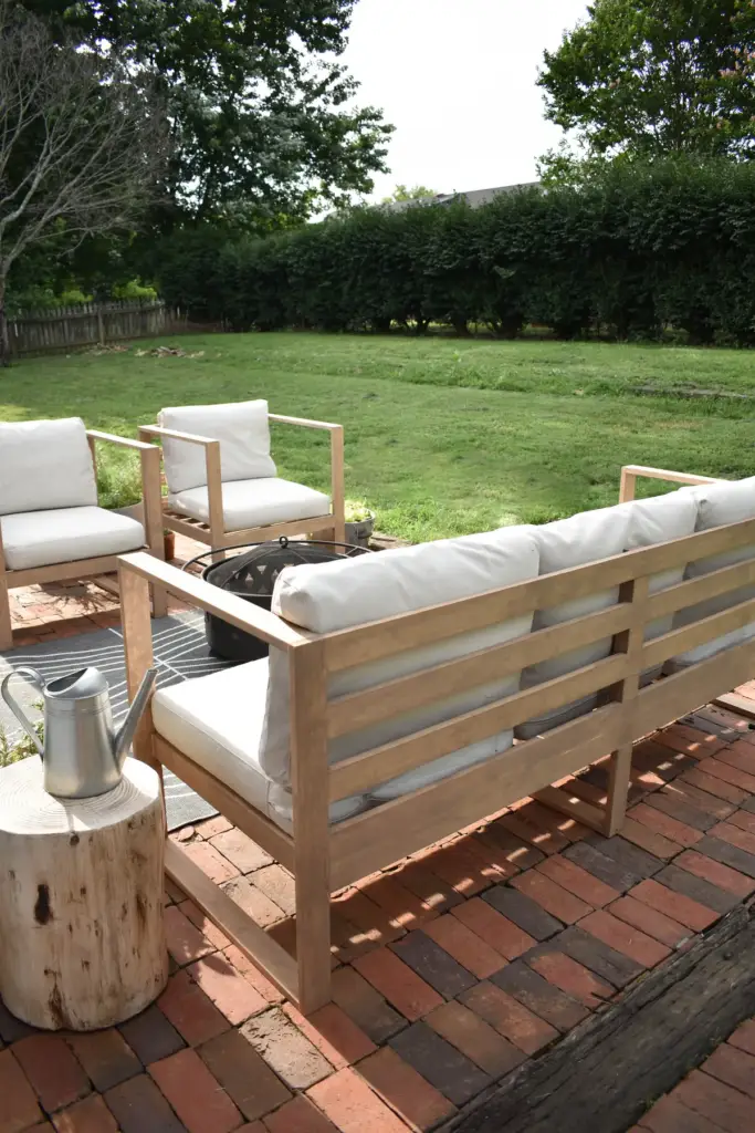 DIY modern outdoor sofa built from cedar with thick outdoor cushions.